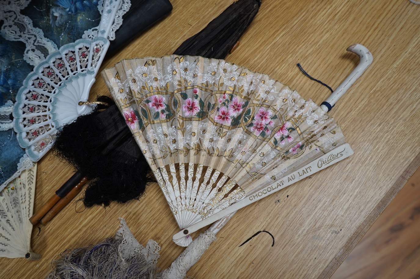 A group of 19th/20th century fans and two parasols, largest fan 33cm, (14). Condition - poor to fair.